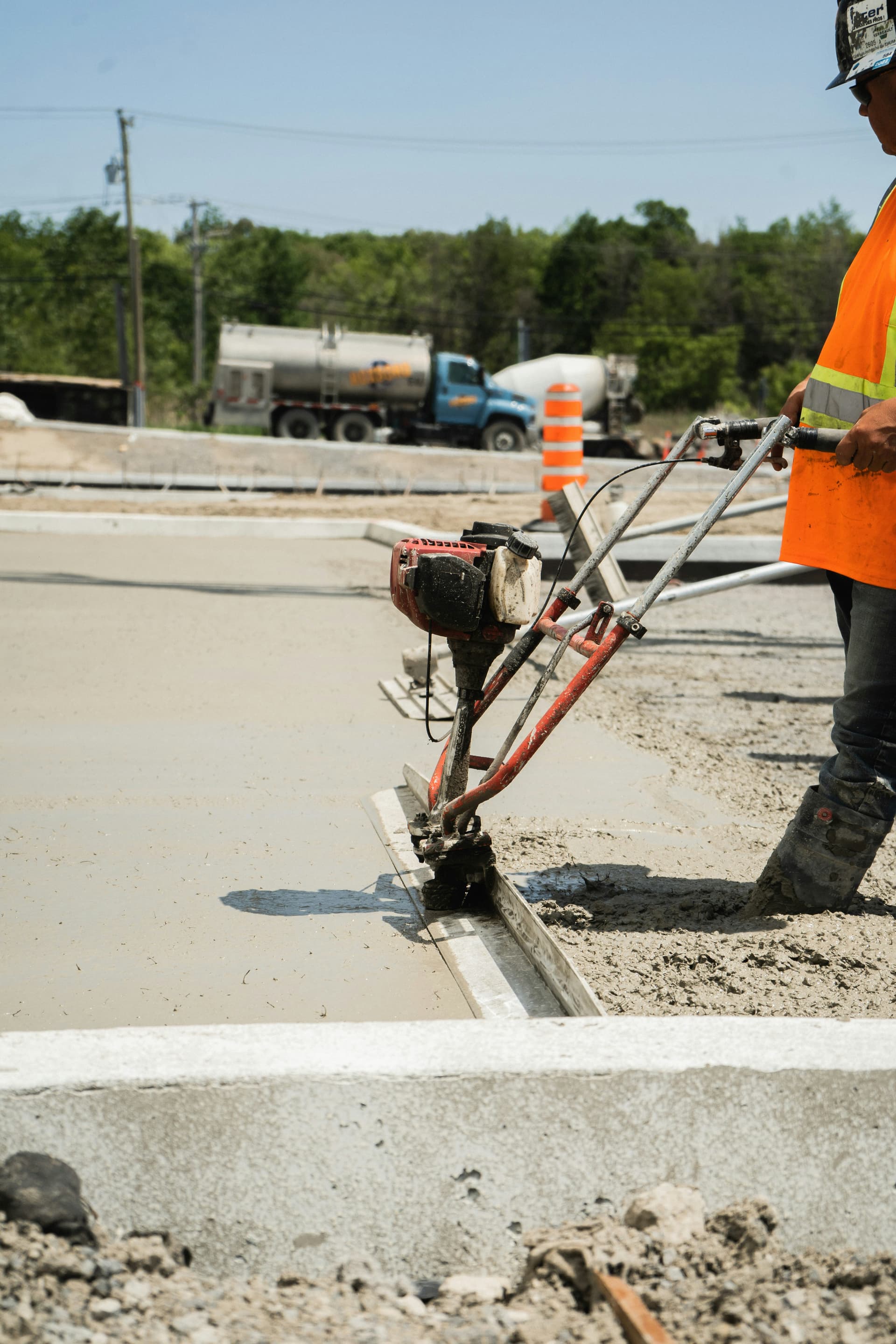 Cutting a control joint into a fresh sidewalk slab